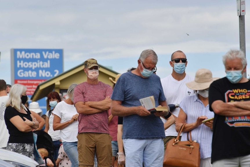 People line up with masks on at the Mona Vale Hospital