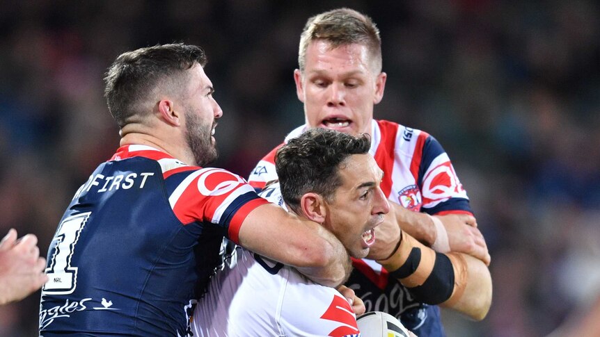 Billy Slater is tackled by James Tedesco in the Storm versus Roosters NRL match in Adelaide.