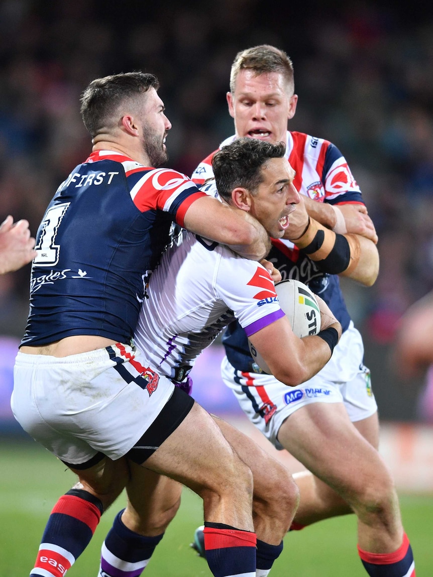 Billy Slater is tackled by James Tedesco in the Storm versus Roosters NRL match in Adelaide.