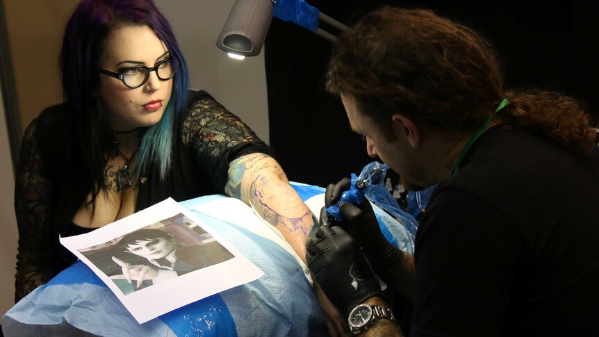Tattoo artist at work at the Australian Tattoo and Body Art Expo in Perth, June 6, 2014.