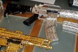Police officers found 31 gold and silver-plated guns of varying calibre studded with diamonds.