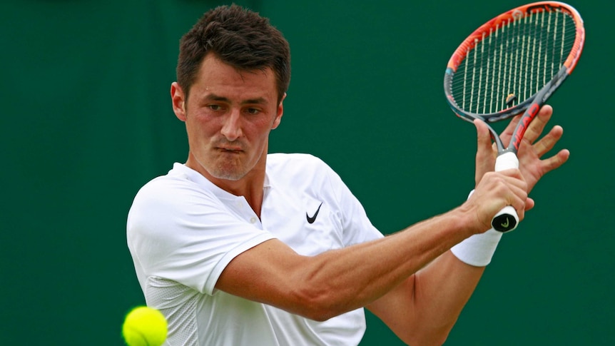 Bernard Tomic slices a backhand back to Fernando Verdasco