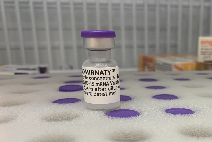 A close up of a COVID-19 vaccine vial