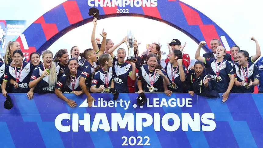 Melbourne Victory celebrate with the A-League Women championship trophy.