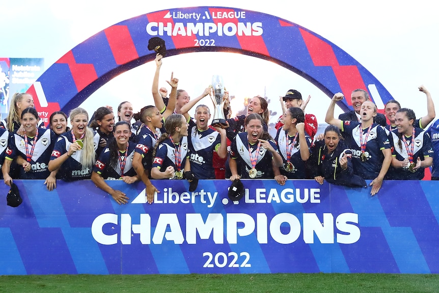 Melbourne Victory celebrate with the A-League Women championship trophy.