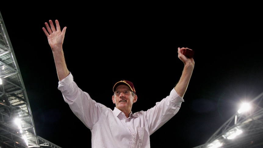 Brisbane Broncos coach Wayne Bennett waves to the crowd at Sydney's Olympic stadium after the 2006 NRL grand final.