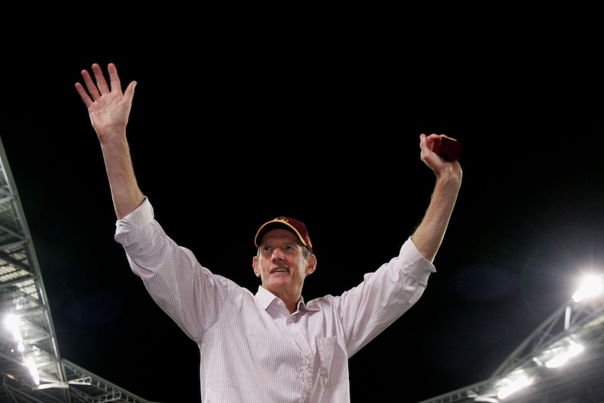 Brisbane Broncos coach Wayne Bennett waves to the crowd at Sydney's Olympic stadium after the 2006 NRL grand final.