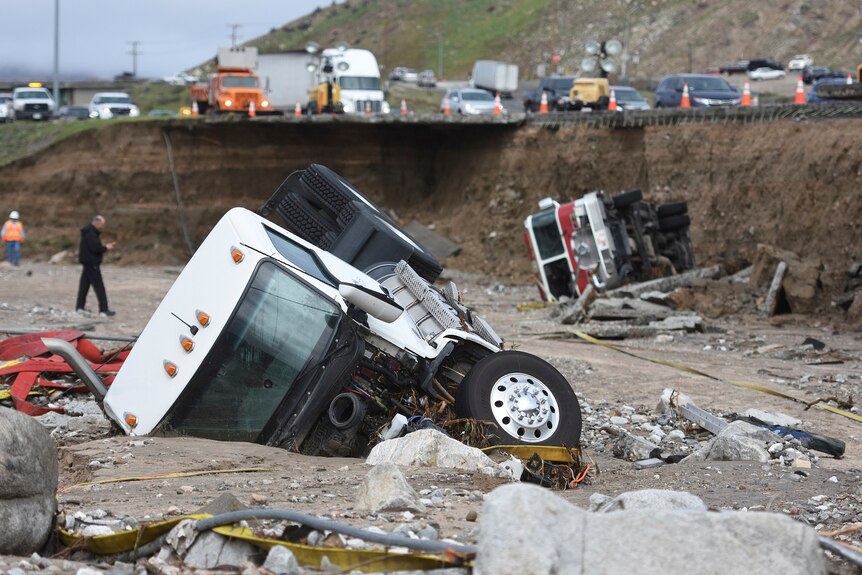 A truck and a fire engine fell from a highway after it collapsed due to heavy rain.