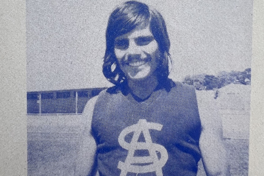 a blue and white print of a football player in guernsey with long brown hair