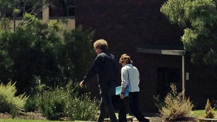 Tasmanian parents Geoffrey Tabain and Hannah Briggs walk away from Magistrates Court in Devonport