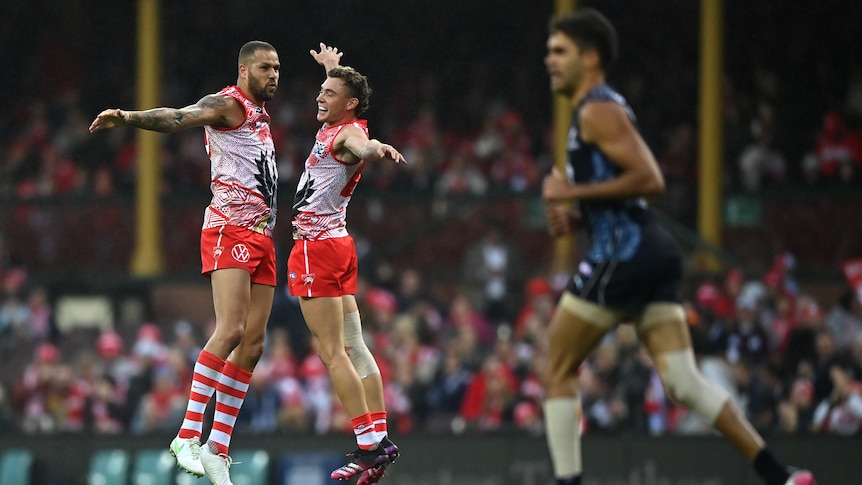 Sydney Swans' Lance Franklin and Will Hayward jump up in the air as they celebrate a goal against Carlton.