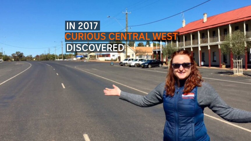 A woman standing with her arms spread on a wide street and the text 'In 2017 Curious Central West discovered'