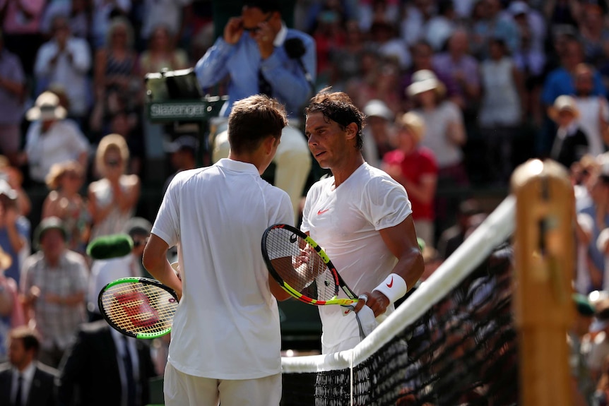 Rafael Nadal and Alex de Minaur shake hands at the net at Wimbledon.