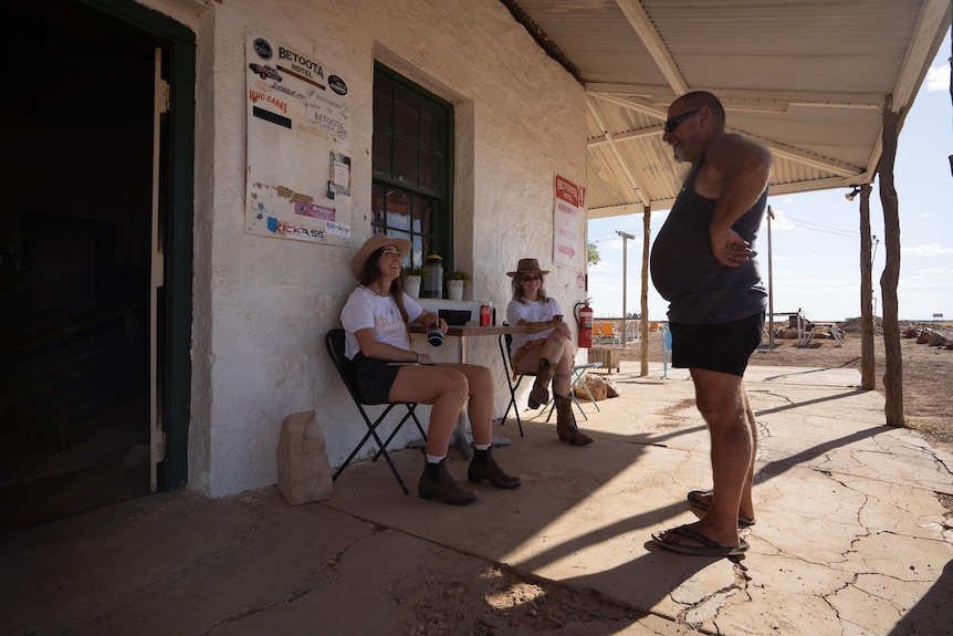 People on the verandah of an outback pub.