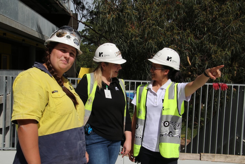 three young women construction workers