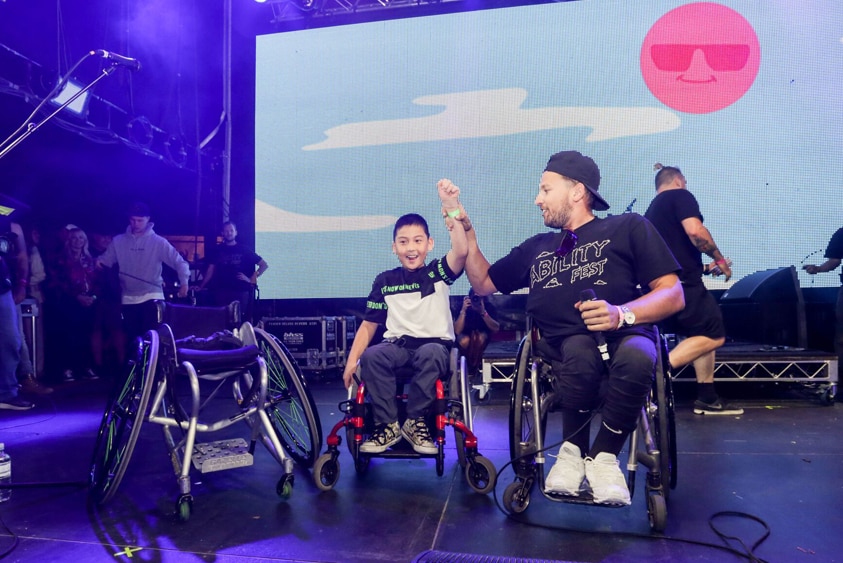Dylan Alcott presenting Jin with a $10,000 wheelchair.