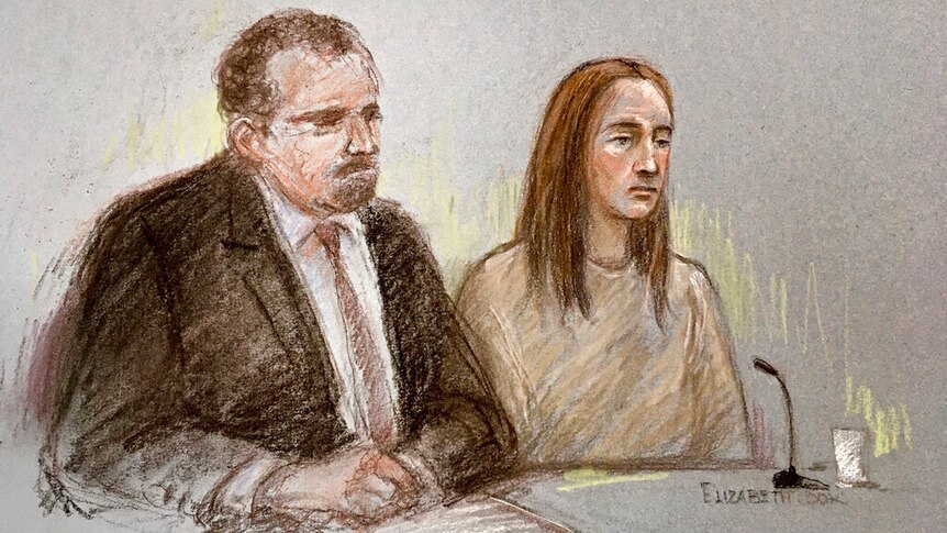 A court sketch of a woman with brown hair wearing beige prison clothing who is sitting next to a lawyer in a black suit.
