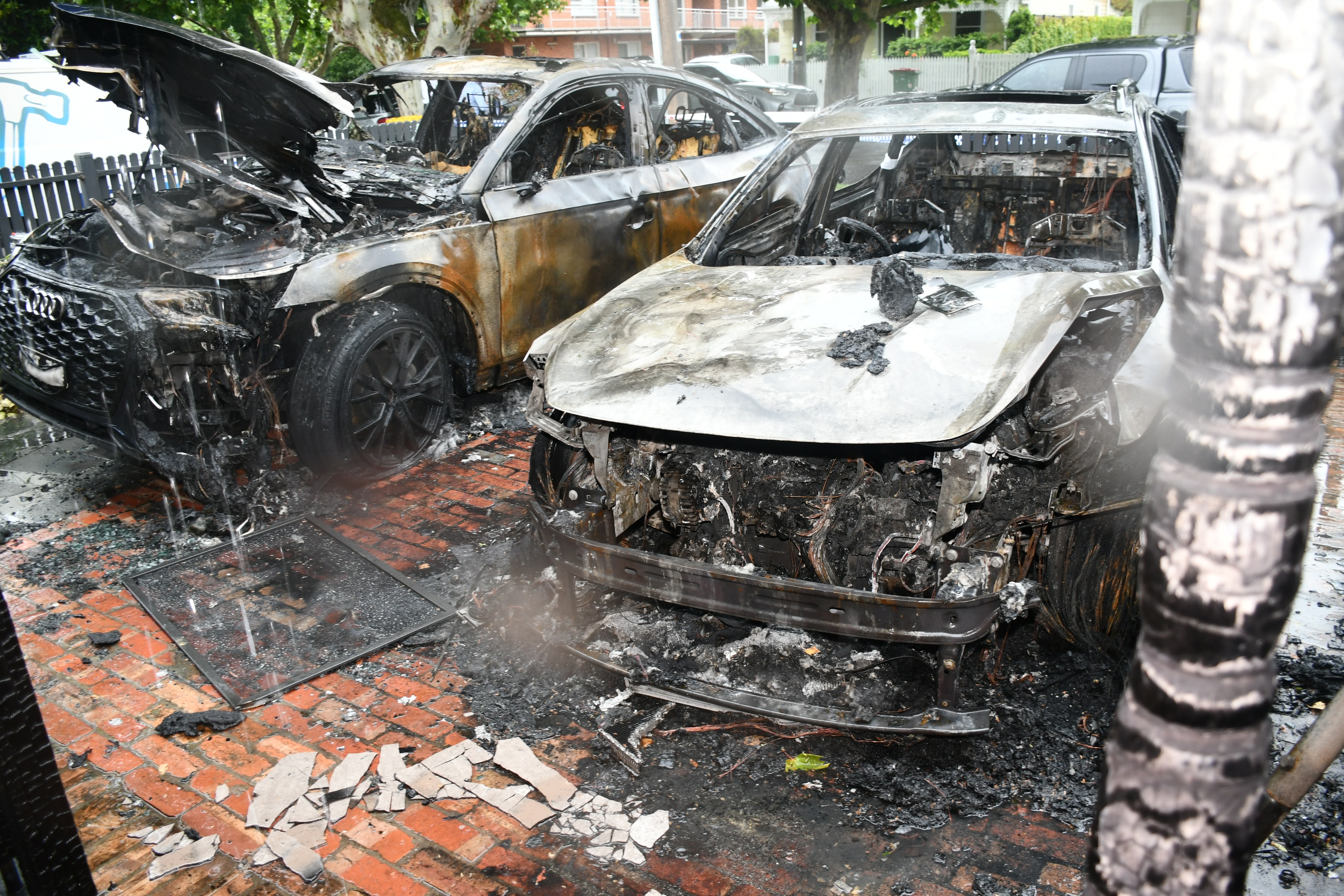 Two burnt cars side by side after an arson attack