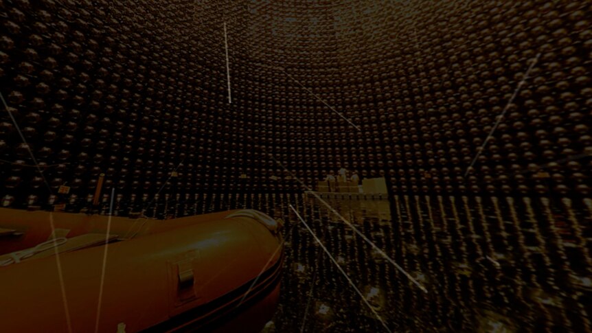 Illustration of particles flying through a giant detector tank lined with lightbulbs.