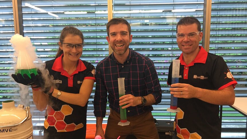 Street Scientists Jess Vokt and Steve Liddell holding test tubes and performing experiments with the ABC's Craig Zonca