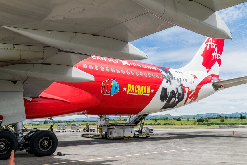 The back of an AirAsia jet with Pac Man livery.