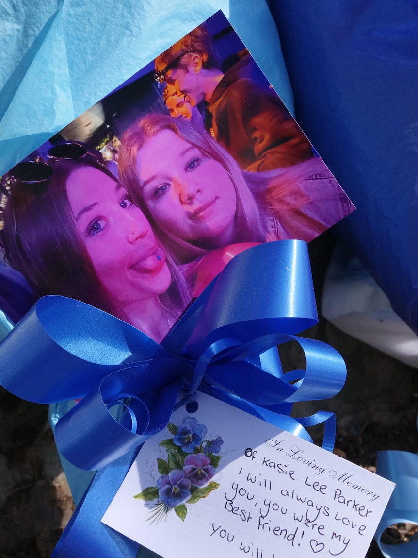 A card and photo of two girls left at a crash site