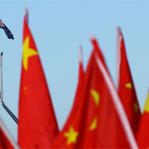 Chinese flags with Australian flag in the background