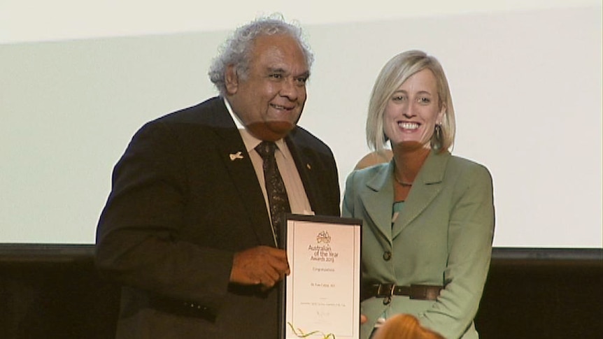 Social justice campaigner Tom Calma accepts his 2013 ACT Australian of the Year Award from Chief Minister Katy Gallagher.