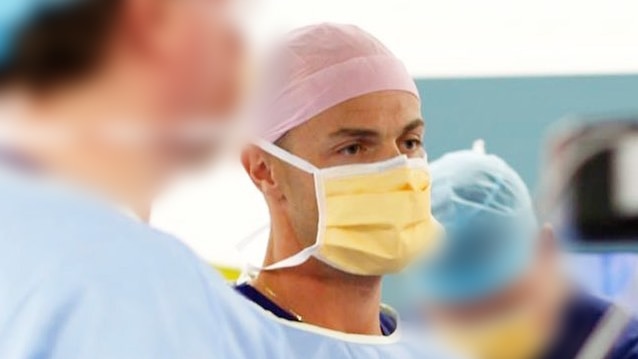 Dr William Braun wears a surgical mask.