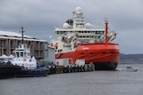 The red-hulled Nuyina next to the dock in Hobart.