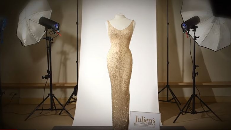 The sequined dress on display against a white backdrop