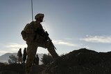 The silhouette of an Australian soldier is pictured against mountains in Afghanistan.