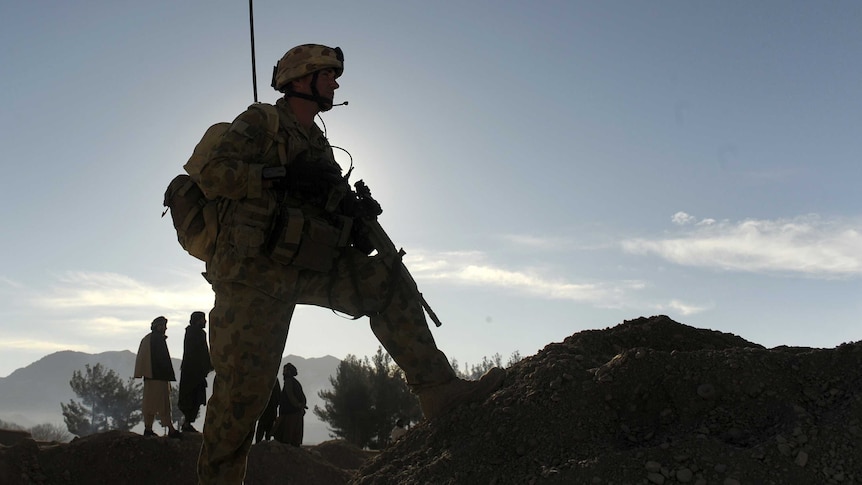 The silhouette of an Australian soldier is pictured against mountains in Afghanistan.