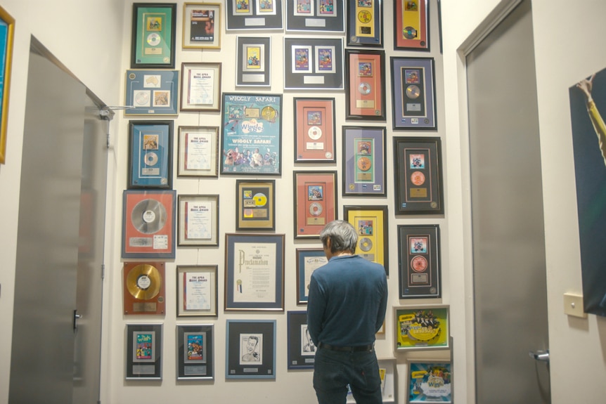 Jeff Fatt from behind, looking at Wiggles memorabilia.