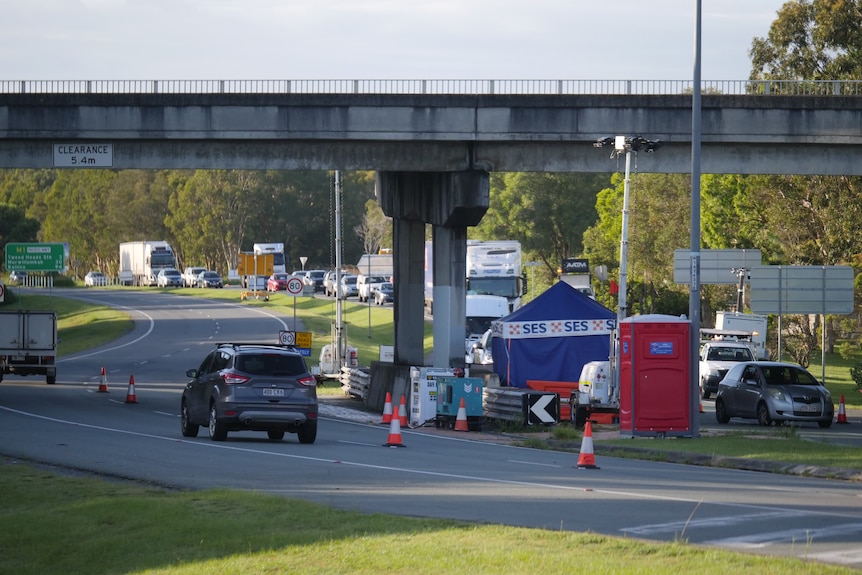 Cars lined up on the M1 at a checkpoint.