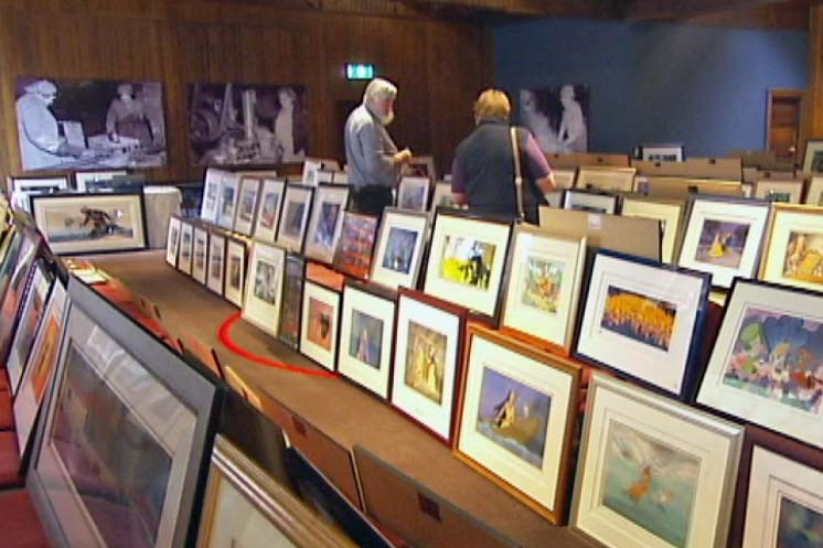 Buyers inspect animated artworks before an auction