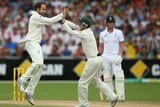 Australia's Nathan Lyon celebrates with George Bailey after taking the wicket of Joe Root.