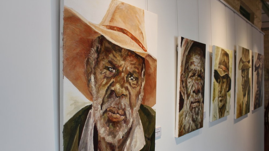 Painting of an aboriginal man in a wide brim hat followed by a row of similar paintings