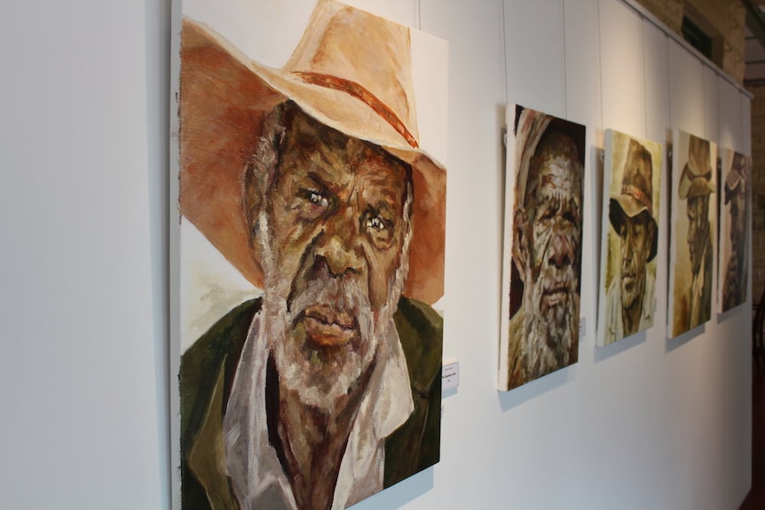 Painting of an aboriginal man in a wide brim hat followed by a row of similar paintings