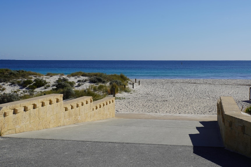 A ramp goes down to Leighton Beach on a sunny day with blue skies