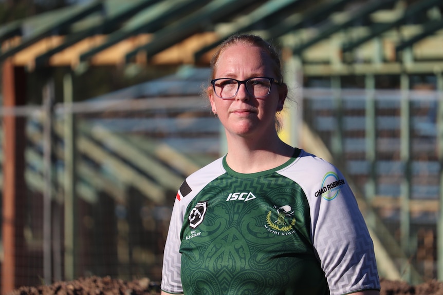 Caite Cooper standing in front of a construction site.