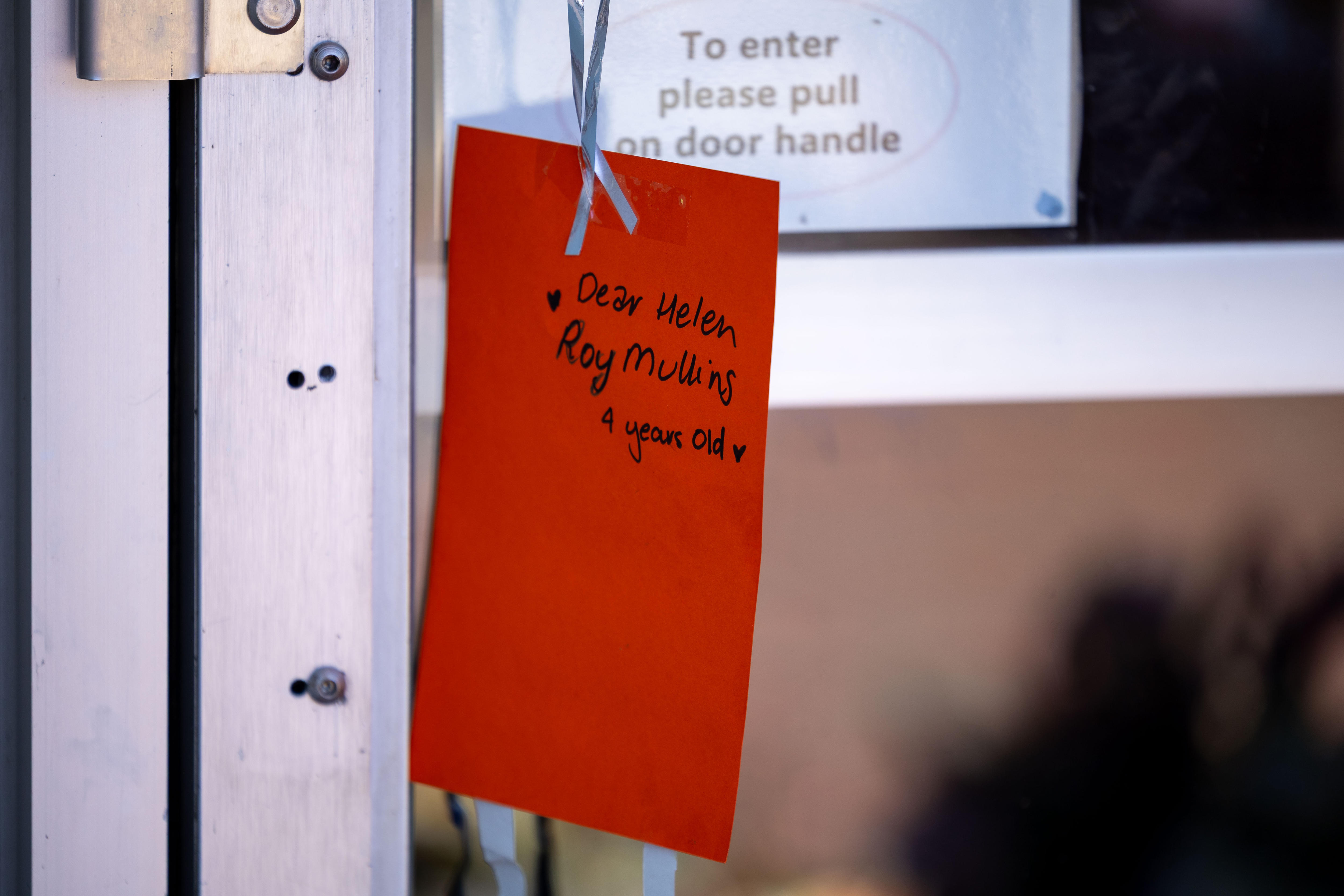 A card attached to a door from Roy Mullins to Helen Haines.