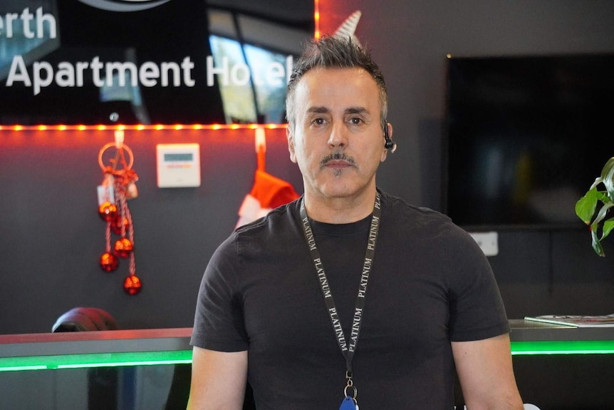 Perth City Apartment Hotel owner Eddie Kamil poses for a photo in the hotel lobby.