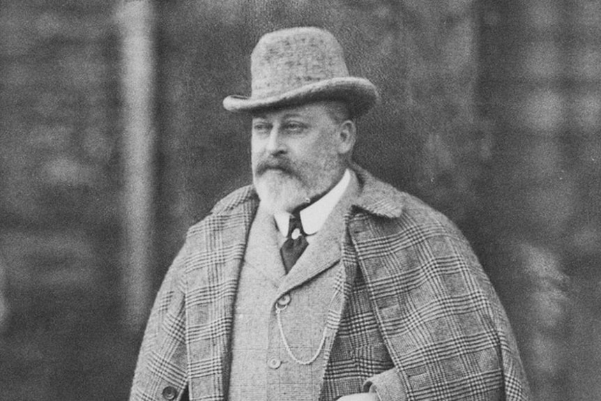 Prince Edward VII in a greyscale photo, wearing a tweed coat, smart hat and waistcoat
