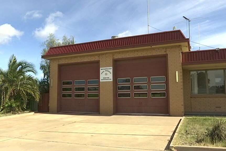 A brown fire station garage