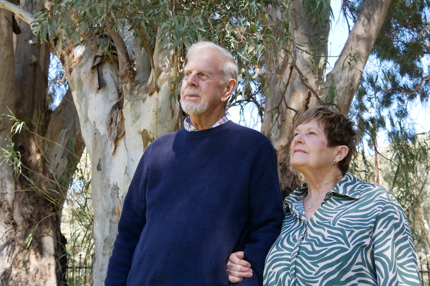 Bob and Jan Moulton standing among gumtrees on their Flinders Rangers farm