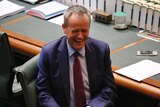 Opposition Leader Bill Shorten bares his teeth while laughing in the House of Representatives