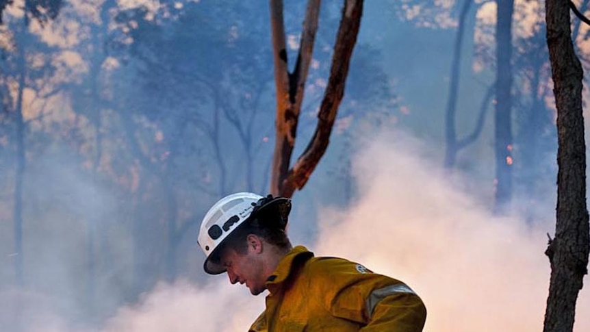 A firefighter attempts to hose down the blaze