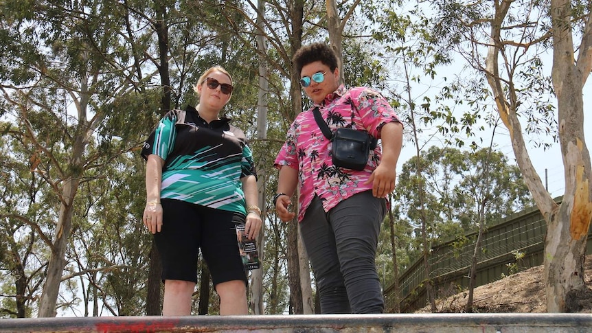 Ms Smith and Mr Hall wearing sunglasses at the top of a skate ramp.