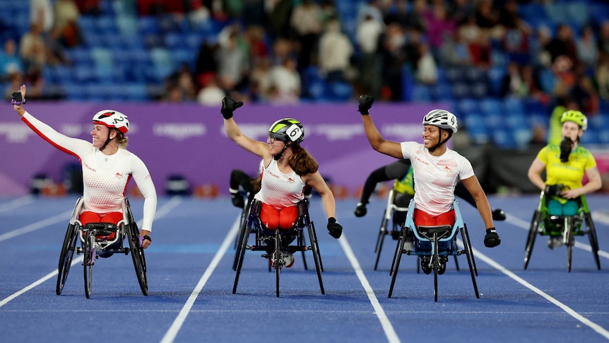 Four female wheelchair racers during an event in a stadium